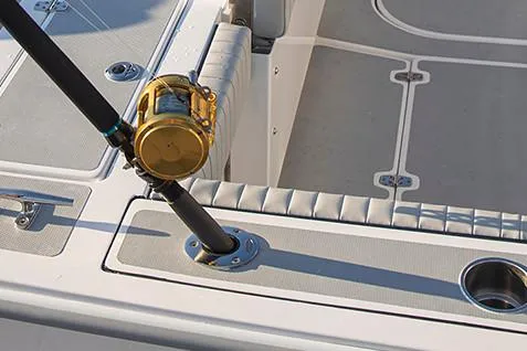 Slide: The Image of Manufacturer Provided Image: Fishing rod holder on 2026 NorthCoast 255 HT boat deck, featuring cushioned seating. - 9