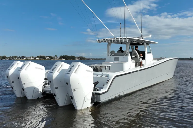 Slide: The Image of 2022 Freeman 47 boat with four Mercury engines on a calm waterway. - 11