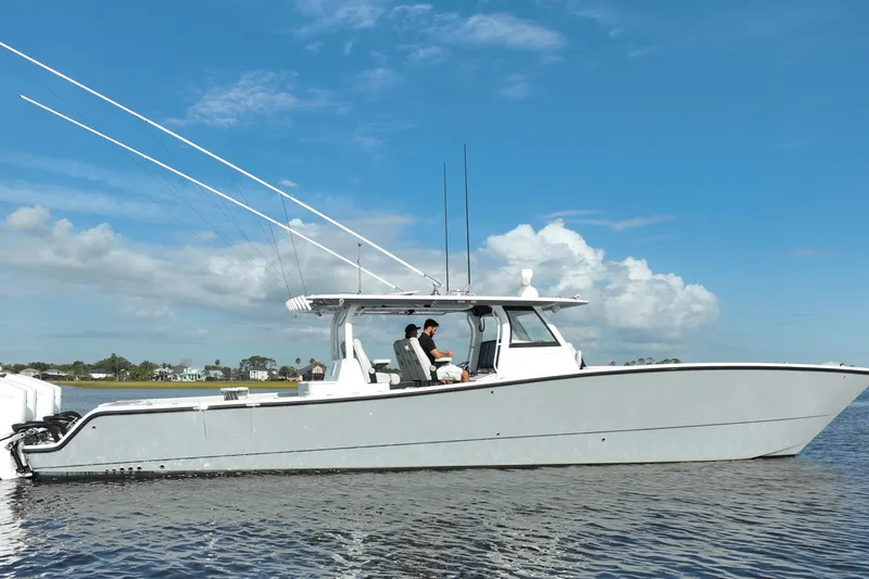 Slide: The Image of 2022 Freeman 47 boat on calm water under a clear blue sky. - 13