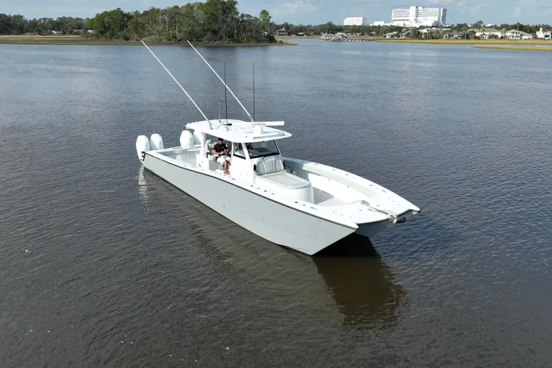 Slide: The Image of 2022 Freeman 47 boat on calm water with scenic background. - 17