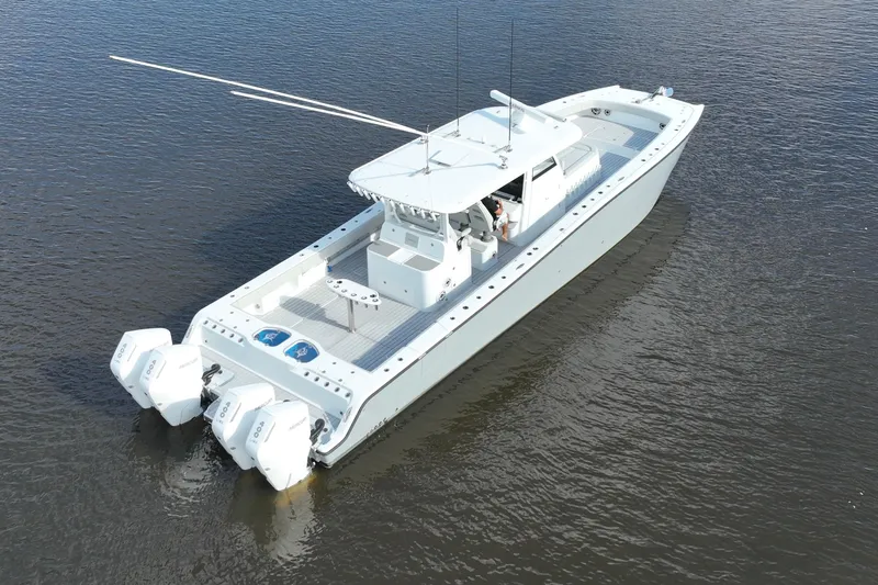 Slide: The Image of 2022 Freeman 47 boat on calm water, featuring multiple outboard engines. - 18
