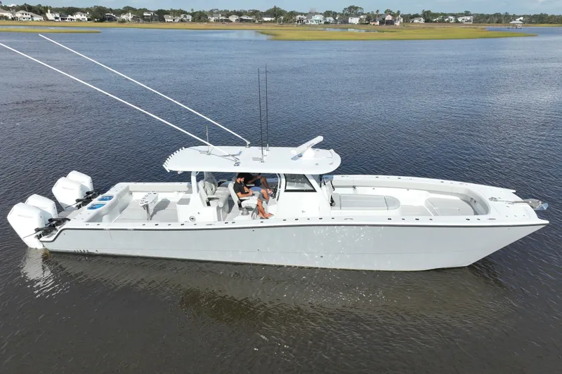 Slide: The Image of 2022 Freeman 47 boat on calm water, featuring sleek design and powerful engines. - 19