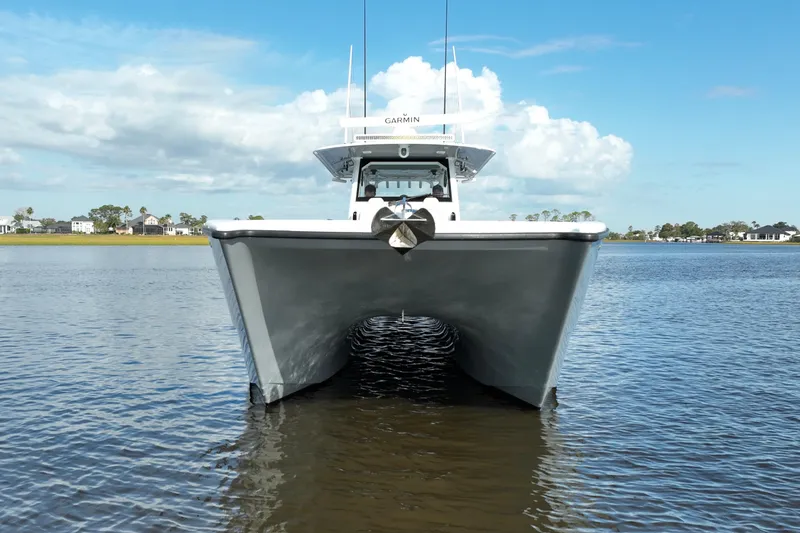 Slide: The Image of Front view of 2022 Freeman 47 catamaran on calm water under blue sky. - 2