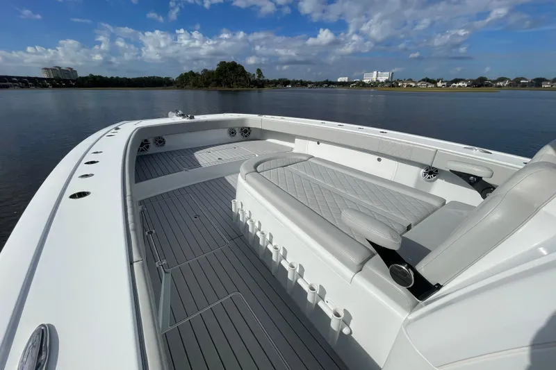 Slide: The Image of 2022 Freeman 47 boat interior with sleek seating and spacious deck on calm water. - 21