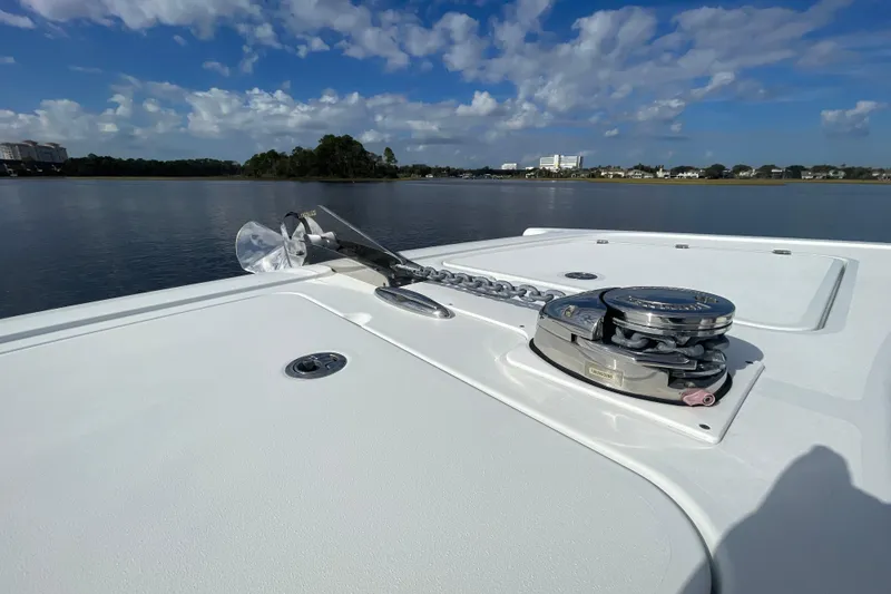 Slide: The Image of Bow of 2022 Freeman 47 boat with anchor and winch, calm water background. - 24
