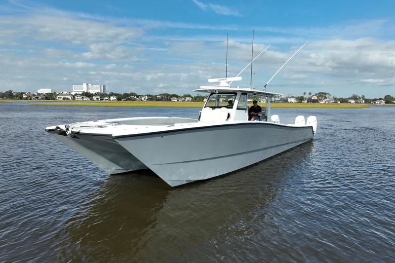 Slide: The Image of 2022 Freeman 47 boat on calm water under a clear blue sky. - 3