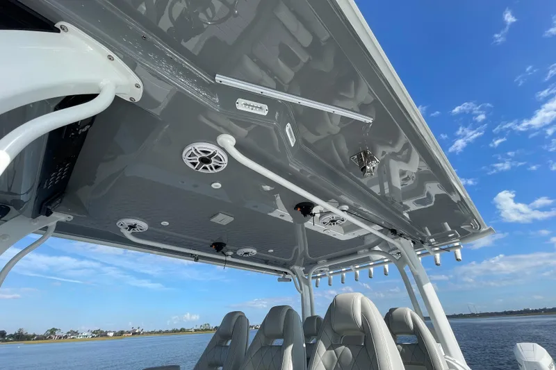 Slide: The Image of 2022 Freeman 47 boat interior with speakers and seating, under a clear blue sky. - 35