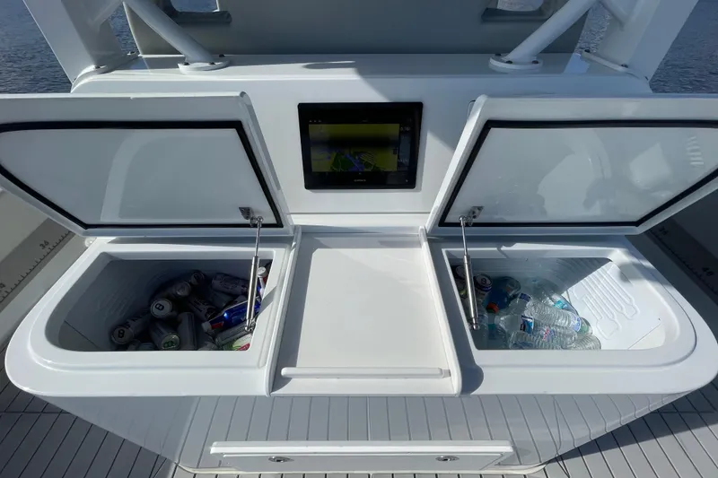 Slide: The Image of Freeman 47 boat cooler compartments with drinks and water bottles, 2022 model. - 37