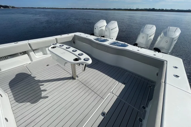 Slide: The Image of Freeman 47 boat deck with multiple outboard motors, 2022 model, on calm water. - 44