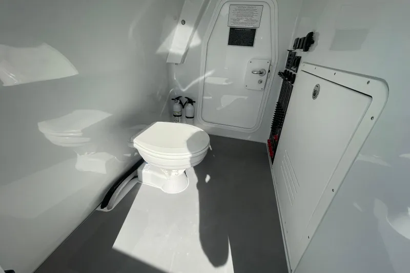 Slide: The Image of Interior of a 2022 Freeman 47 boat featuring a compact marine toilet. - 46