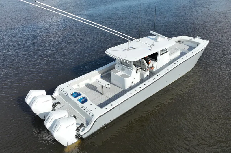 Slide: The Image of 2022 Freeman 47 boat with triple Mercury engines on calm water. - 50