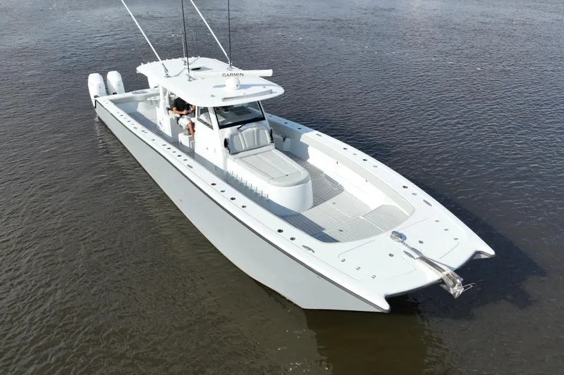 Slide: The Image of 2022 Freeman 47 boat on calm water, featuring sleek design and twin engines. - 51