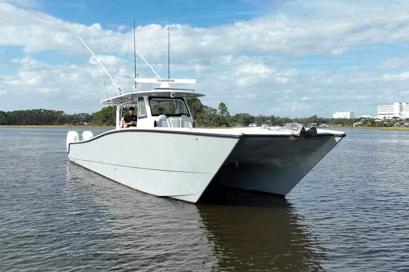 Slide: The Image of 2022 Freeman 47 boat on calm water under a partly cloudy sky. - 55