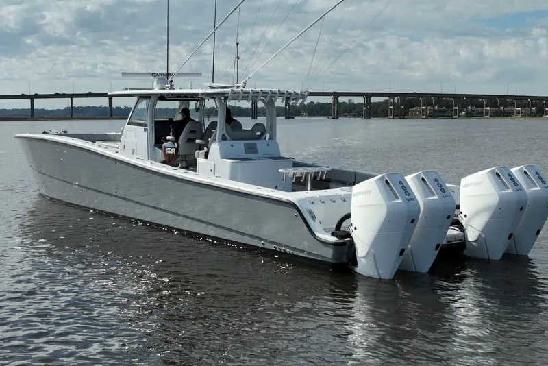 Slide: The Image of 2022 Freeman 47 boat with four Mercury engines on calm water. - 8