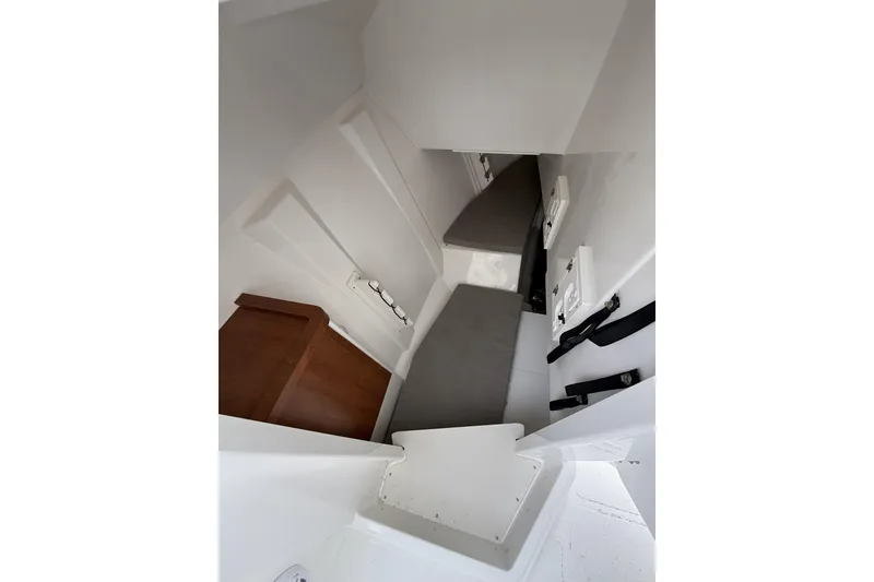 Slide: The Image of Interior cabin of 2026 Pursuit DC 306 Dual Console boat, featuring seating and storage. - 13