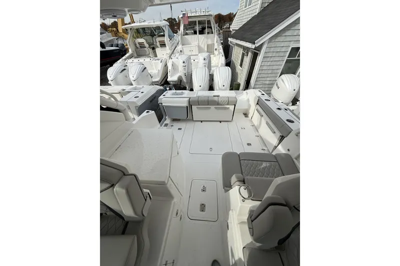 Slide: The Image of 2026 Pursuit DC 306 Dual Console boat interior with seating and multiple outboard engines. - 9