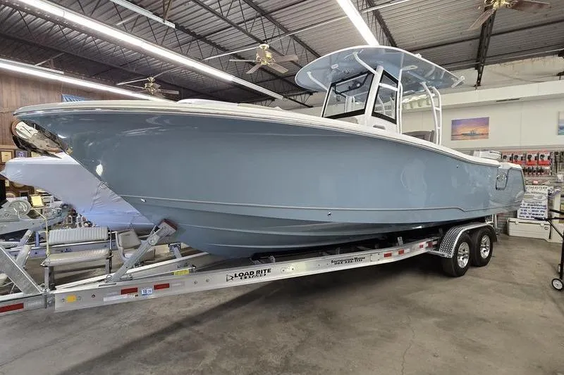The Image of 2026 Sea Hunt Ultra 285 SE boat on trailer in showroom. - 1