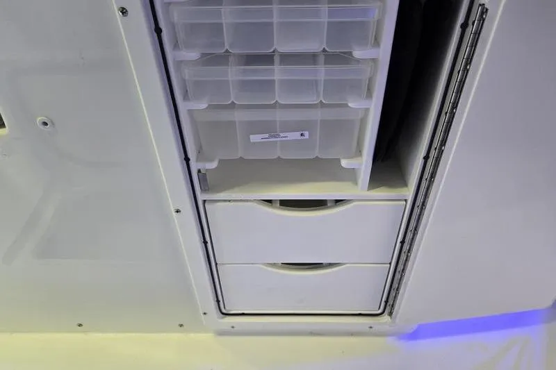Slide: The Image of Storage compartment on a 2026 Sea Hunt Ultra 285 SE boat, featuring organized drawers. - 10