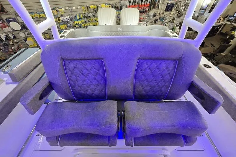 Slide: The Image of 2026 Sea Hunt Ultra 285 SE boat seating with blue lighting and quilted design. - 12