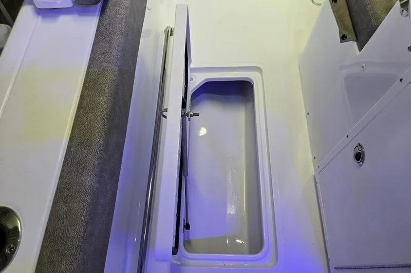 Slide: The Image of Open storage compartment on 2026 Sea Hunt Ultra 285 SE boat deck. - 15