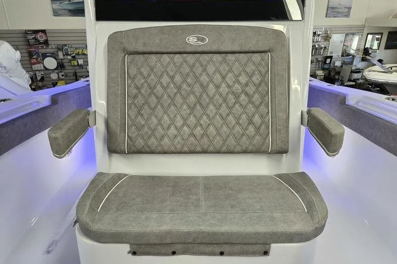 Slide: The Image of 2026 Sea Hunt Ultra 285 SE boat seat with diamond-patterned upholstery and armrests. - 17