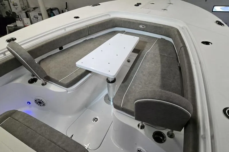 Slide: The Image of 2026 Sea Hunt Ultra 285 SE boat interior with gray seating and white table. - 19