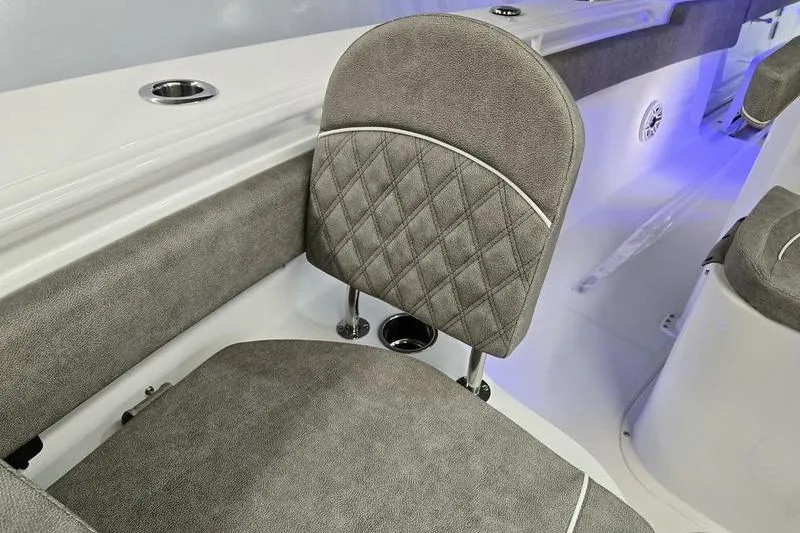 Slide: The Image of 2026 Sea Hunt Ultra 285 SE boat interior with gray cushioned seating and blue accent lighting. - 20