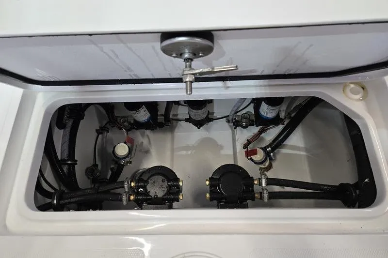Slide: The Image of 2026 Sea Hunt Ultra 285 SE boat compartment with mechanical components and wiring. - 27