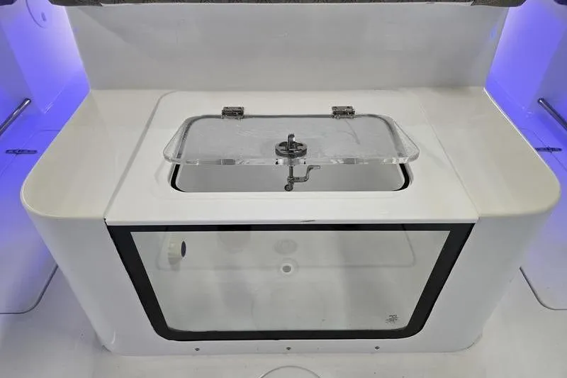 Slide: The Image of Livewell on 2026 Sea Hunt Ultra 285 SE boat, featuring a transparent lid and modern design. - 28