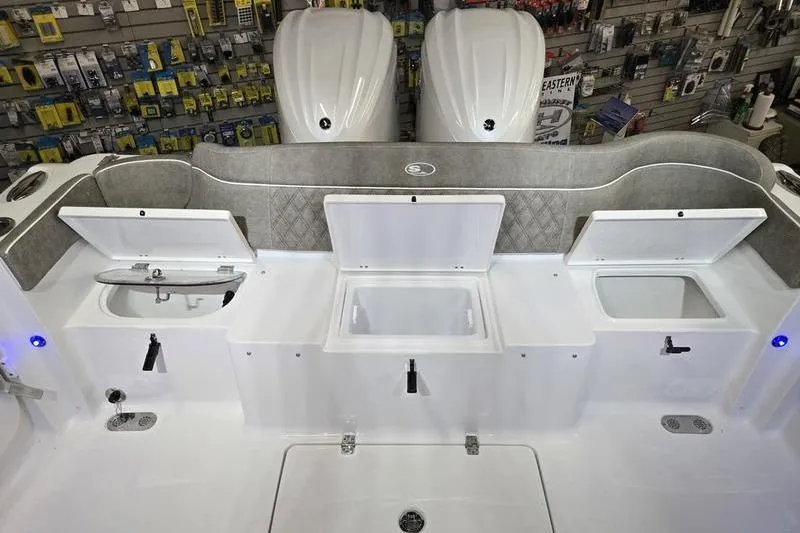 Slide: The Image of 2026 Sea Hunt Ultra 285 SE boat interior with storage compartments and dual engines. - 29