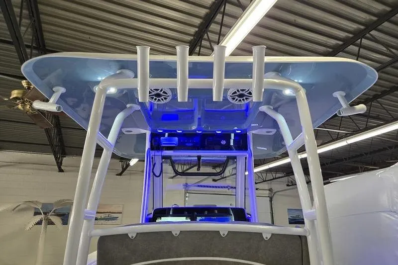 Slide: The Image of 2026 Sea Hunt Ultra 285 SE boat with blue LED lighting and rod holders. - 5