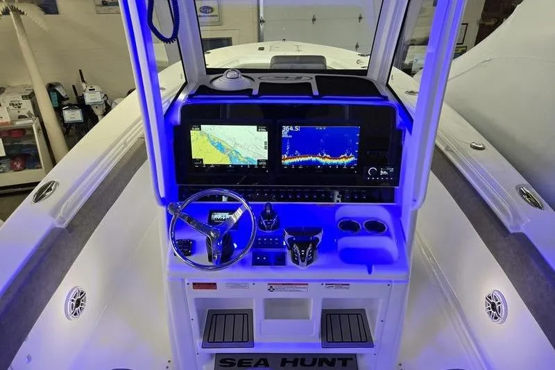 Slide: The Image of 2026 Sea Hunt Ultra 285 SE boat dashboard with navigation screens and controls. - 8
