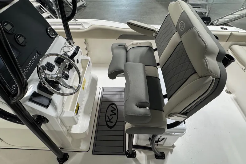 Slide: The Image of 2026 Key West 239 FS boat interior with steering console and cushioned seating. - 13