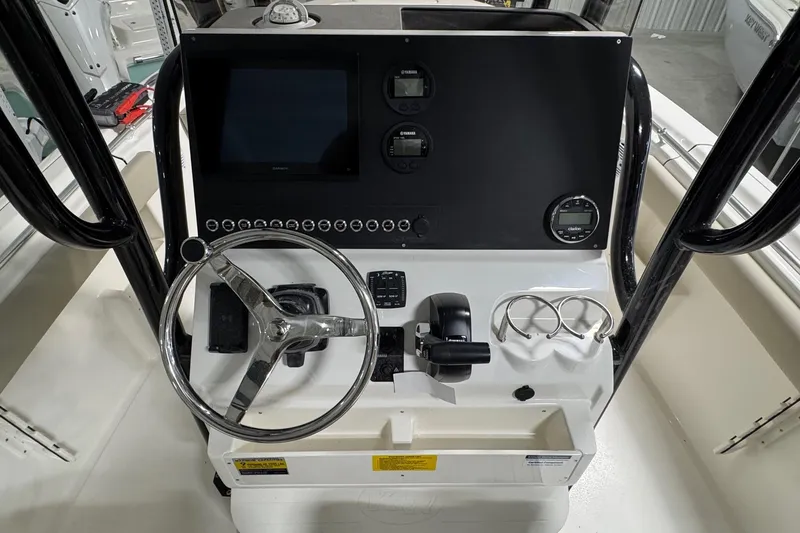 Slide: The Image of 2026 Key West 239 FS boat dashboard with steering wheel and electronic controls. - 14