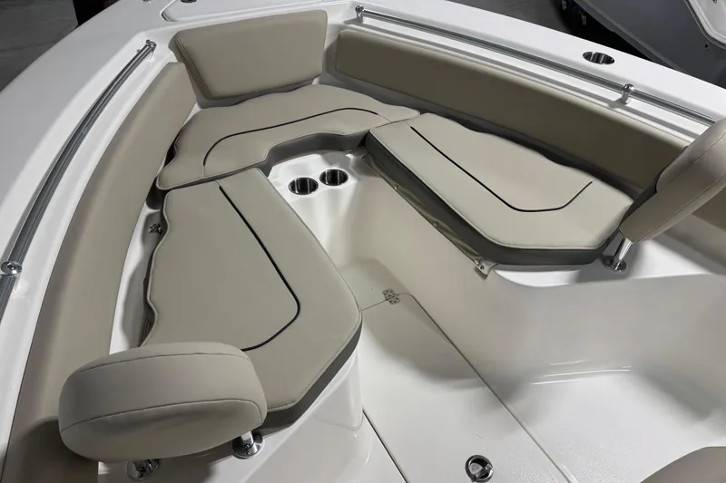 Slide: The Image of 2026 Key West 239 FS boat interior with beige cushioned seating and cup holders. - 7
