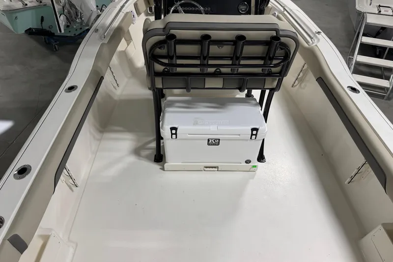 Slide: The Image of 2026 Key West 239 FS boat interior with seating and cooler storage. - 19
