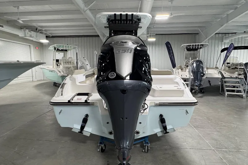 Slide: The Image of 2026 Key West 239 FS boat with powerful outboard motor in a showroom. - 4