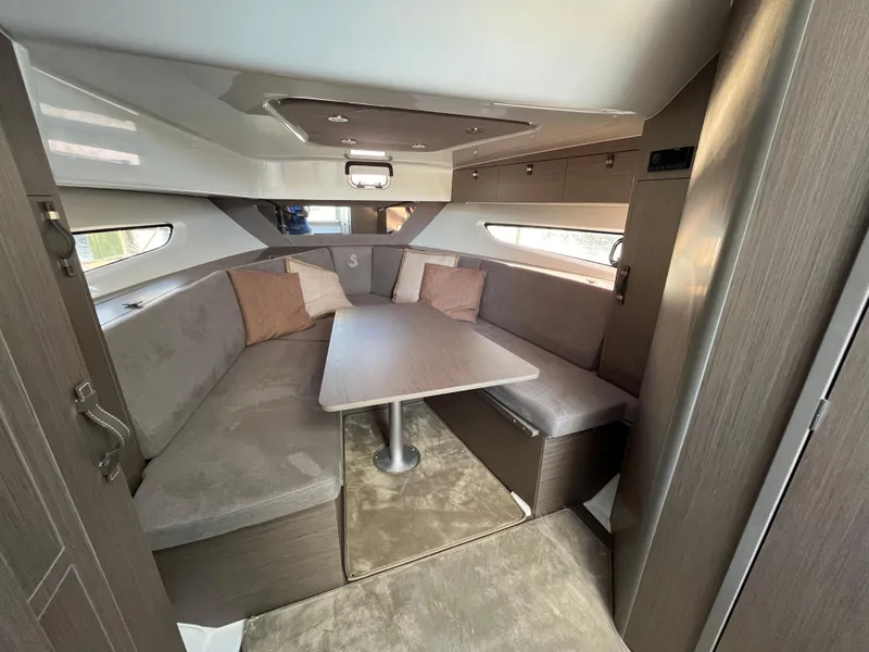 Slide: The Image of 2024 Beneteau Gran Turismo 32 Inboard cabin with cozy seating and table. - 20