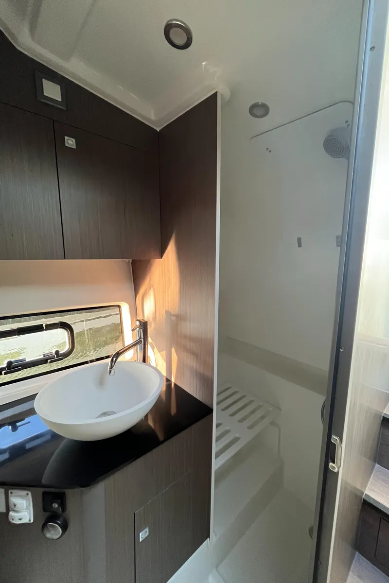 Slide: The Image of 2024 Beneteau Gran Turismo 32 Inboard bathroom with modern sink and sleek cabinetry. - 22