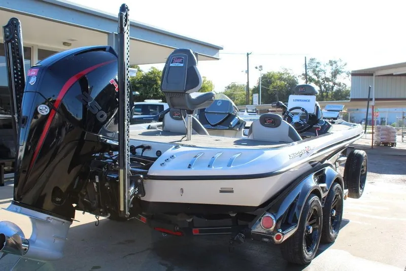 Slide: The Image of 2019 Ranger Z521 Comanche boat with powerful outboard motor, parked outdoors. - 3