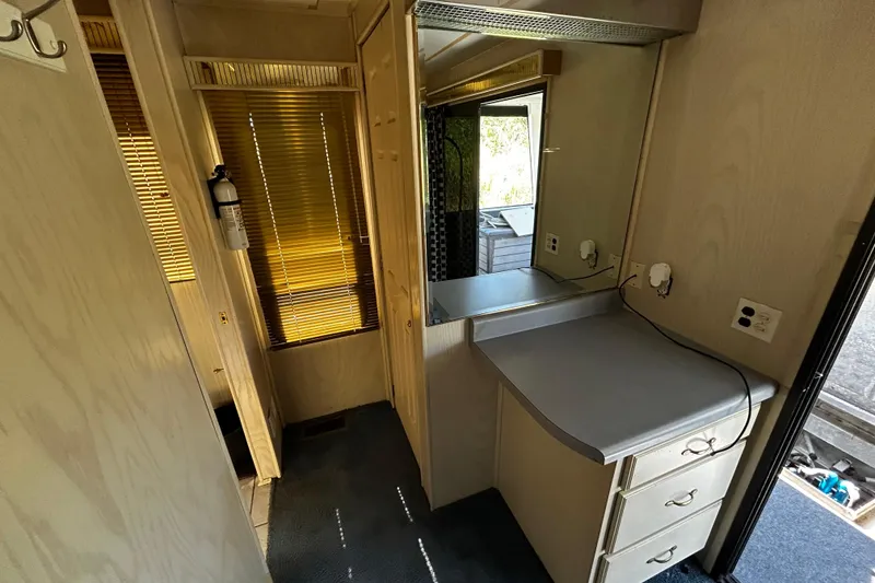 Slide: The Image of Interior of 1997 Monticello River Yacht, featuring a compact vanity and window blinds. - 11