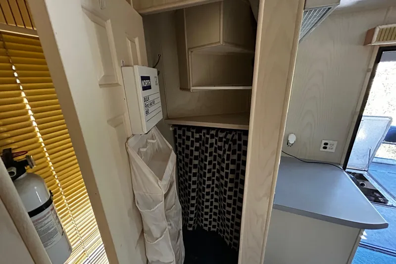Slide: The Image of Interior of 1997 Monticello River Yacht with storage, first aid kit, and fire extinguisher. - 16