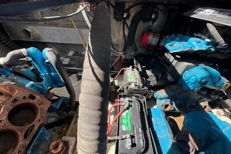 Slide: The Image of Engine compartment of a 1997 Monticello River Yacht, showcasing mechanical components and wiring. - 27