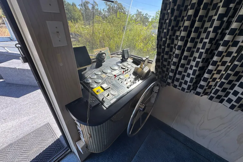 Slide: The Image of Control panel of a 1997 Monticello River Yacht, featuring steering wheel and instruments. - 3