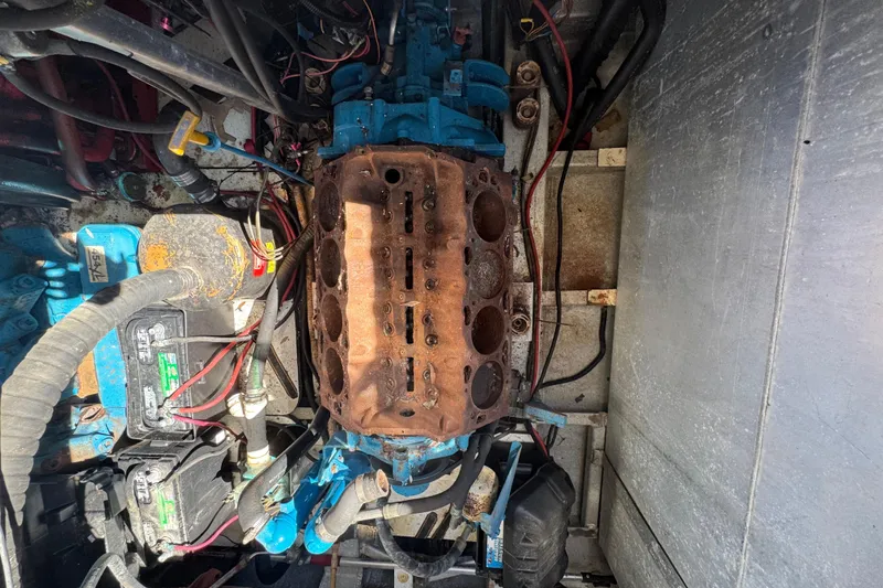 Slide: The Image of Engine compartment of a 1997 Monticello River Yacht, showing exposed engine components. - 30