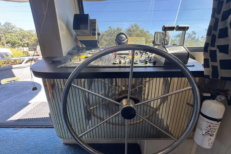 Slide: The Image of Steering wheel and control panel of a 1997 Monticello River Yacht - 60'. - 4