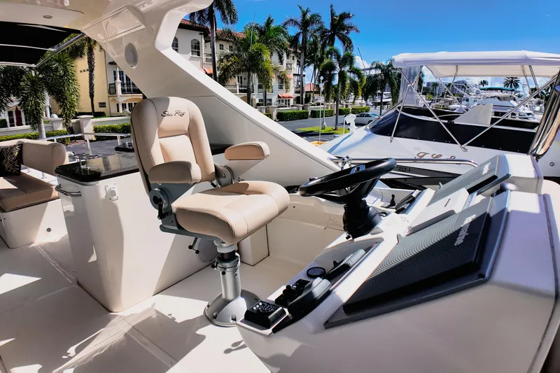 Slide: The Image of 2016 Sea Ray L590 Fly yacht docked in a sunny marina. - 1