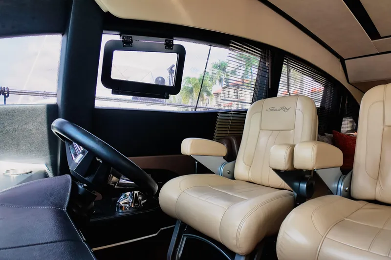 Slide: The Image of Helm of 2016 Sea Ray L590 Fly yacht with modern controls and panoramic view. - 10
