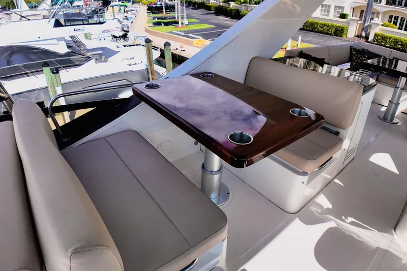 Slide: The Image of Flybridge helm of 2016 Sea Ray L590 Fly yacht with steering wheel and navigation controls. - 22