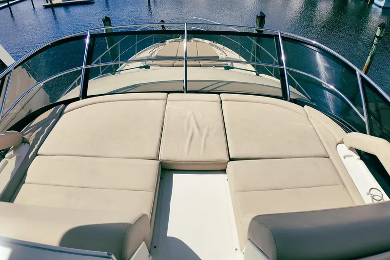 Slide: The Image of Luxurious seating area on 2016 Sea Ray L590 Fly yacht with polished wood table. - 23
